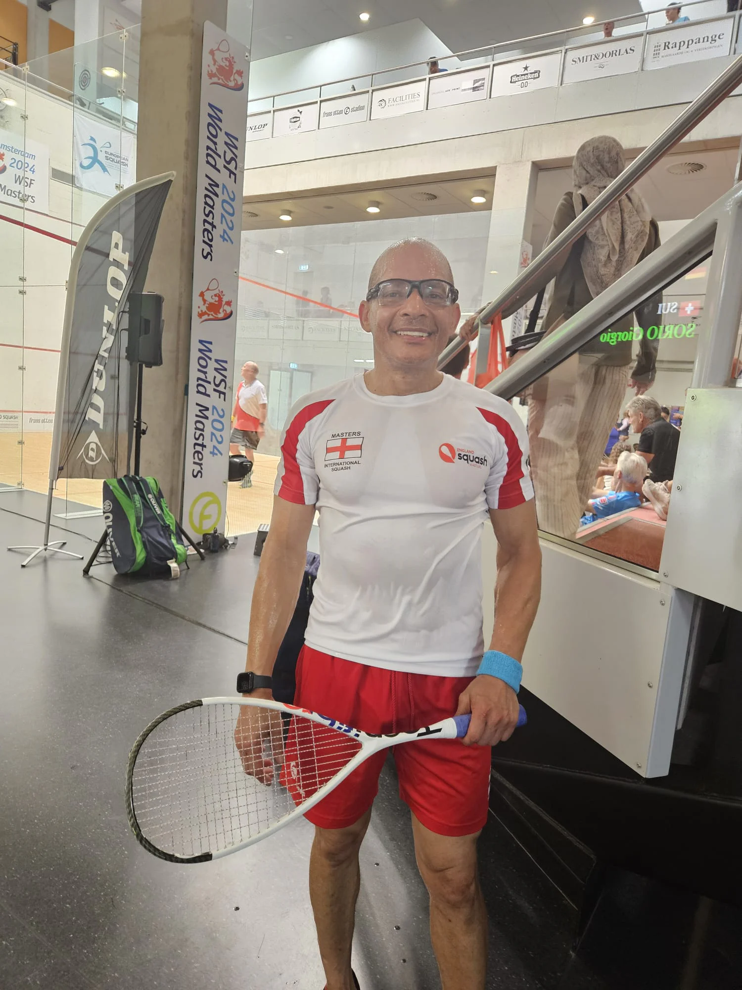 Teejay Sogunro in England kit with a squash racket at the WSF World Masters championships