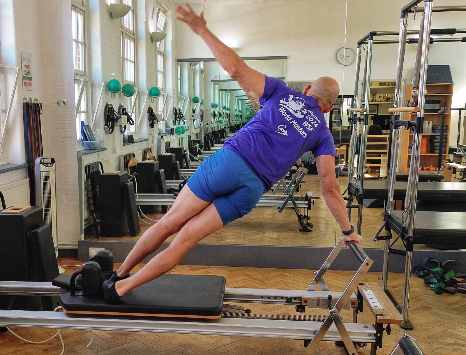 Side plank held on the Reformer, building trunk capacity, at Applied Pilates, London Colney, St Albans