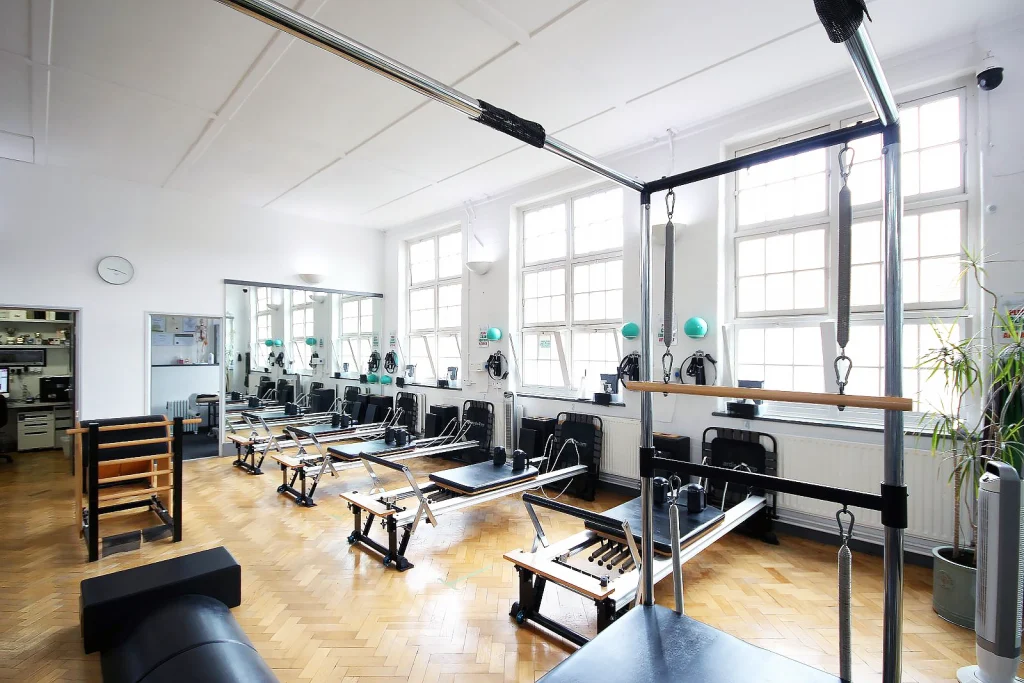 Reformers along the window wall with the Cadillac in the foreground at Applied Pilates, London Colney, St Albans