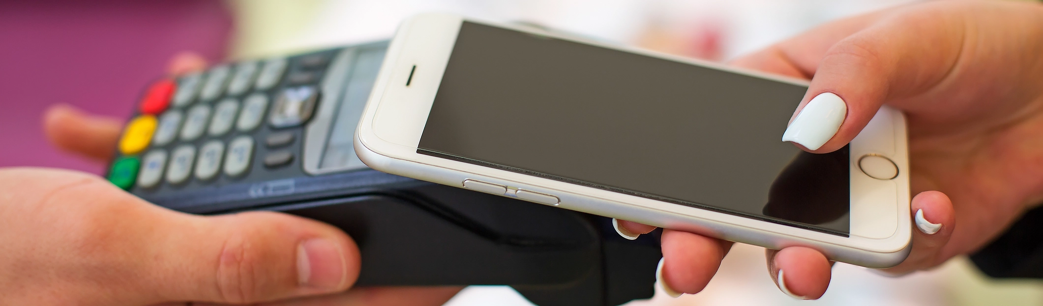 Contactless payment being made with a phone at a card terminal