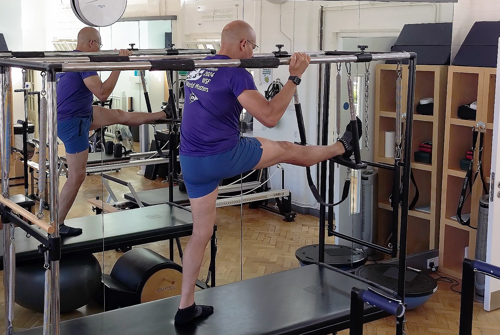 Assisted hamstring work on the Cadillac in the STOTT Pilates apparatus studio at Applied Pilates, London Colney