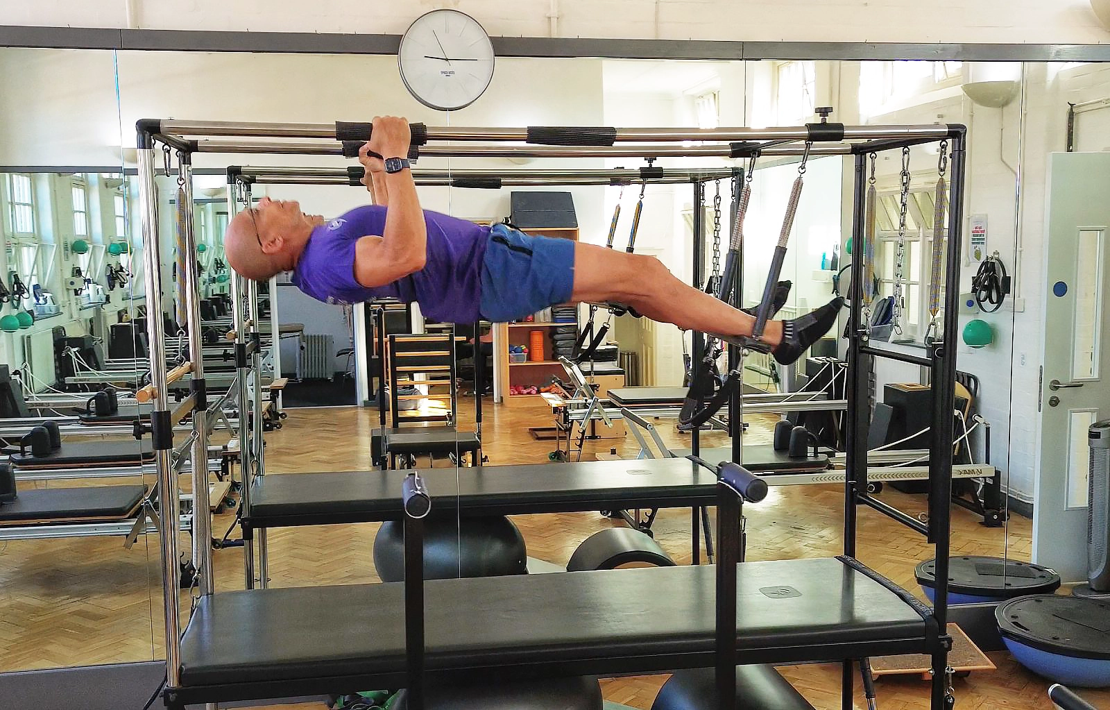 Teejay Sogunro performing pull-ups on the Cadillac at The Sogunro Practice, London Colney, St Albans